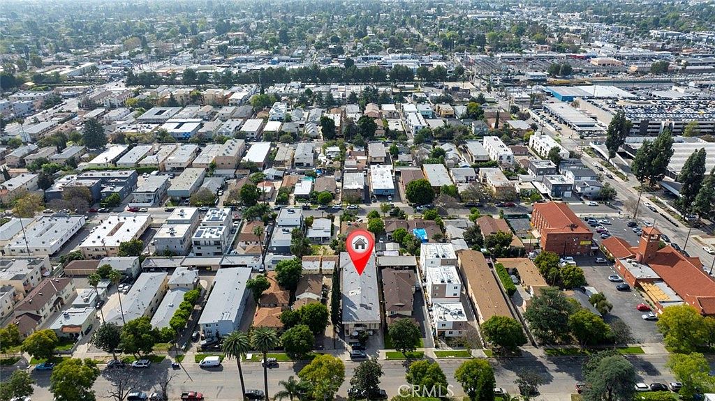 Aerial view of 14218 Sylvan Street marked by a pin, sitting in dense Sherman Oaks multi-family fabric two blocks south of Ventura Boulevard with the 405 freeway visible in the distance